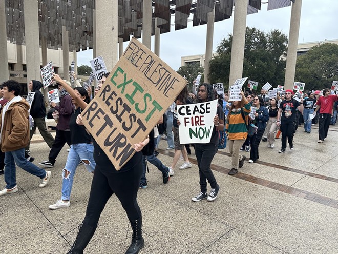 Students at the University of Texas at San Antonio march through the Sombrilla plaza at the school's main campus Thursday. - Michael Karlis