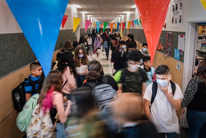 Students walk between classes at Chapa Middle School in Kyle. The State Board of Education on Friday approved five eighth grade science textbooks that will for the first time be required to include material on climate change. - Texas Tribune / Jordan Vonderhaar