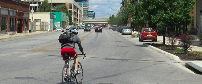 A cyclist peals through downtown San Antonio. - Sanford Nowlin