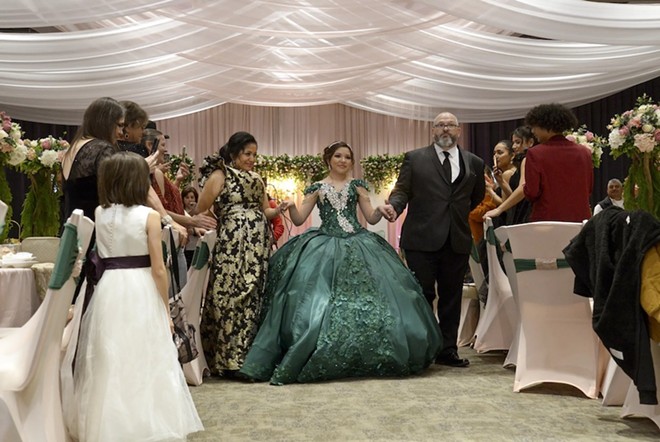 Sienna Raley, flanked by her parents Maria and Troy, begins the Grand Entrance at her quinceañera Saturday, Dec. 16, in Diboll. - Texas Tribune / Joel Andrews