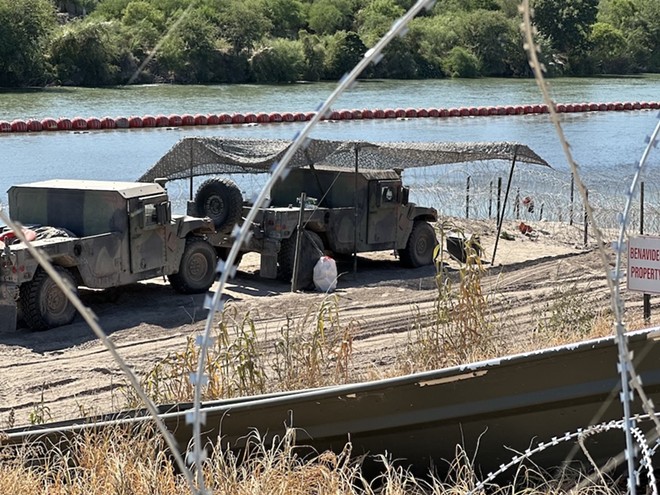 Texas National Guardsmen watch for migrants along the banks of the Rio Grande near Eagle Pass. - Michael Karlis