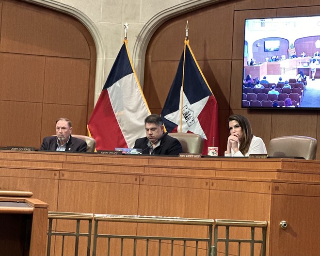 District 8 City Councilman Manny Pelaez clacks away on his laptop while San Antonio residents express their concerns about the bloodshed in Gaza. - Michael Karlis