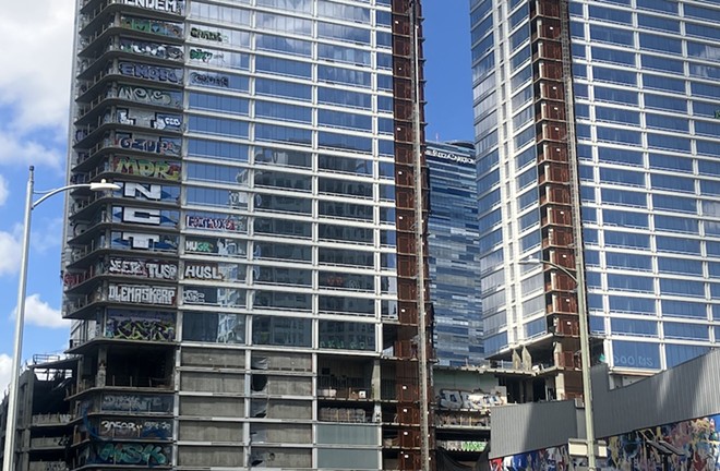 A trio of empty luxury condo towers in Los Angeles sit unfinished across the street from the Crypto.com Arena. - Heywood Sanders