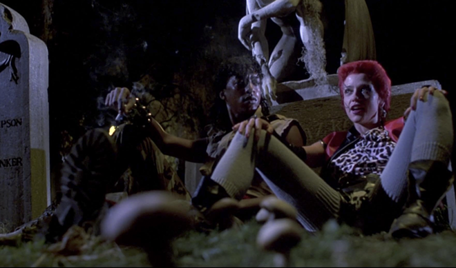 Miguel Nunez and Linnea Quigley share a scene in the graveyard in 1985's Return of the Living Dead. - Orion Pictures