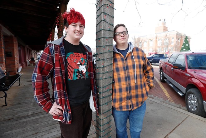 Marcus Stovall and Bear Bright stand on the sidewalk across the street from the courthouse on Dec. 9, 2023 in Canyon. - Texas Tribune / Mark Rogers