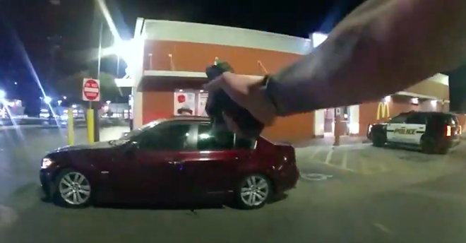 Former SAPD officer James Brennand points a weapon at a maroon BMW driven by Erik Cantu on Oct. 22, 2022. - Screen Capture: YouTube / San Antonio Police Department