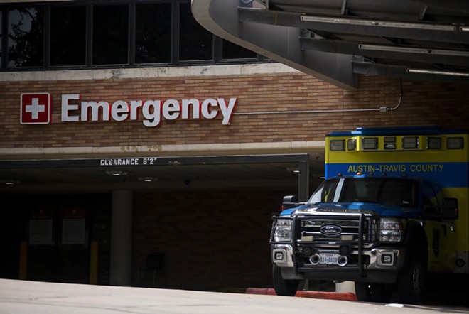 An Austin-Travis County EMS unit parked near a hospital's emergency entrance in Austin on July 7, 2020. - Texas Tribune / Allie Goulding