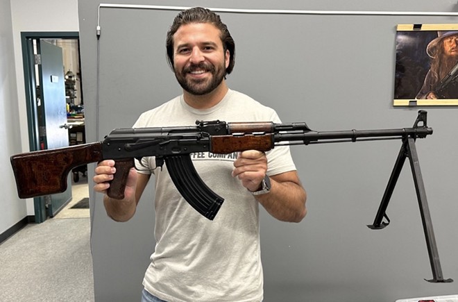 Congressional candidate Brandon Herrera holds up a replica Romanian RPK his campaign is raffling off. - X / @TheAKGuy
