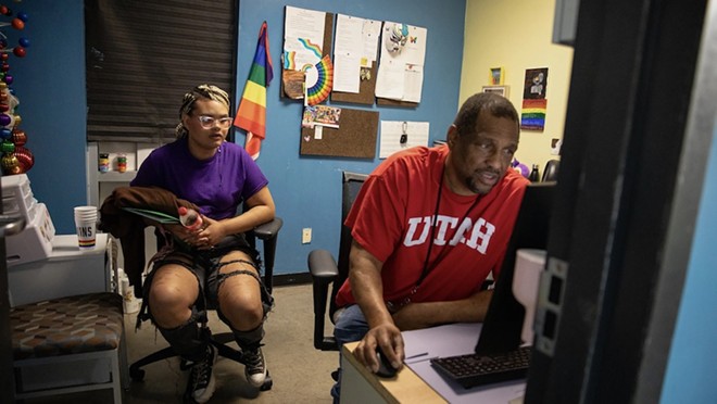 Isabella Morningstar talks with Marcus Anthony, a case manager at Thrive Youth Center in San Antonio as he looks for an update on her new birth certificate. After she aged out of the foster care system in 2020, she had a difficult time updating her paperwork to reflect her legal name and gender marker. - Texas Tribune / Greta Díaz González Vázquez