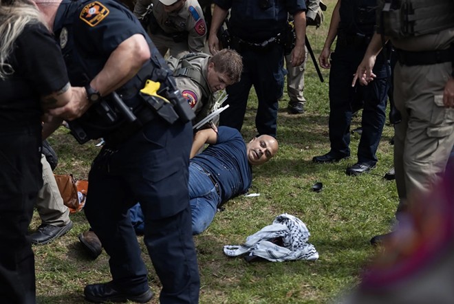 Carlos, a FOX 7 photojournalist, lays on the ground as he is arrested while covering a pro-Palestinian demonstration at the University of Texas at Austin on April 24, 2024. - Texas Tribune / Julius Shieh