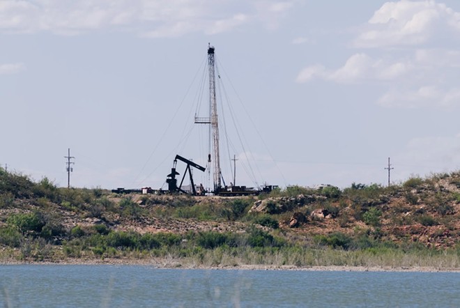 An oil well adjacent to the Red Bluff Reservoir in Reeves County on Feb. 24, 2020. NGL Water Solutions Permian has proposed discharging treated produced water into the reservoir. - Inside Climate News / Justin Hamel