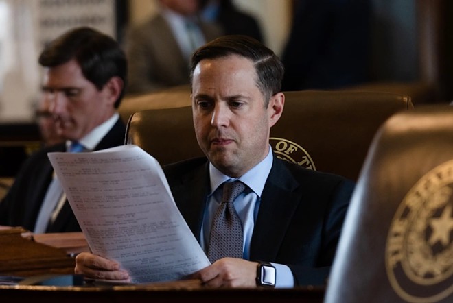 State Rep. Dustin Burrows, R-Lubbock, examines a document at his desk on the House floor during a session at the state Capitol in Austin on April 25, 2023. - Texas Tribune / Evan L'Roy