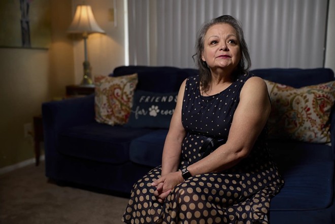 Mary Ann Estrella sits inside her apartment in Midland on April 20. - Texas Tribune / Reilly Strand