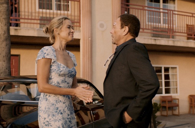 Kristanna Loken (left) shares a moment with Jean-Claude Van Damme in the new action-thriller Darkness of Man. - Saban Films