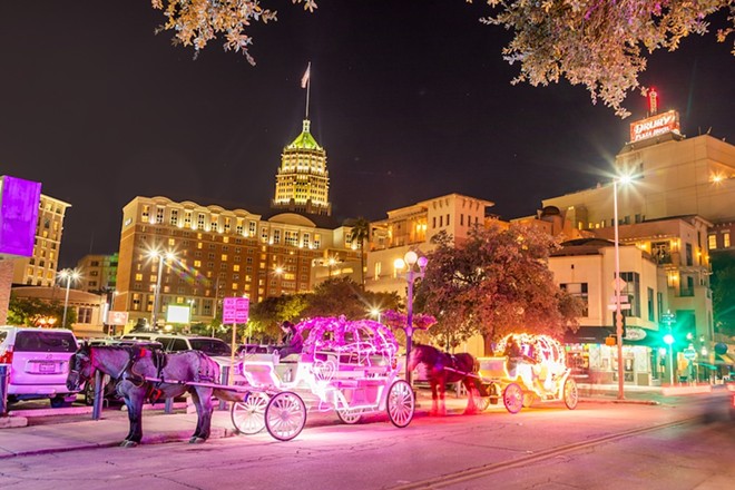 Horse drawn carriages line up at night in downtown San Antonio. - Shutterstock / travelview