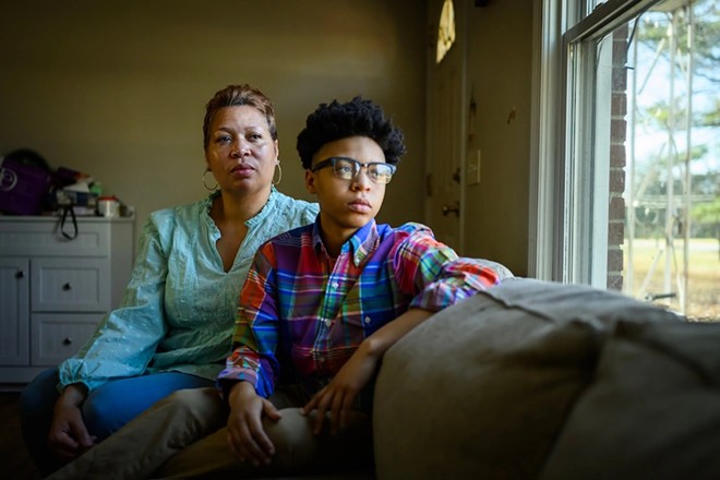 DiJuana Davis, with daughter Treasure Woodard, at home in Nashville, Tennessee. Davis is a plaintiff in a class-action lawsuit contesting the state’s Medicaid eligibility process. She and her children lost their coverage in 2019 after Tennessee launched a Deloitte-built eligibility system. - KFF Health News / William DeShazer