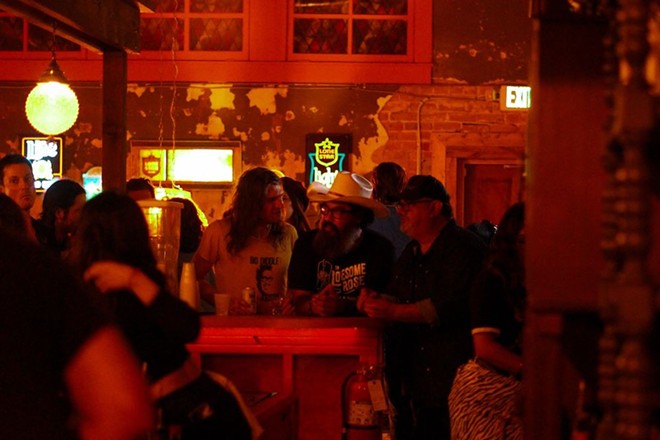 Patrons enjoy adult beverages surrounded by' 70s decor during the opening night of Slow Ride. - Christopher Hernandez / Instagram: @TejanoChris