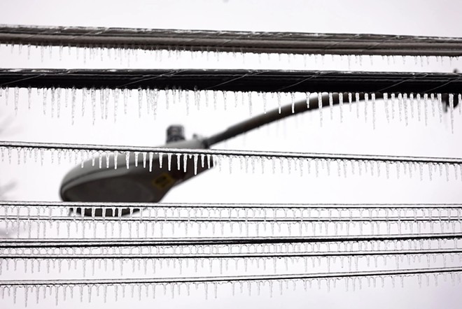 Icicles hang from telephone poles and power lines after an ice storm in north Austin on Feb. 1, 2023. Credit: - Texas Tribune / Evan L'Roy