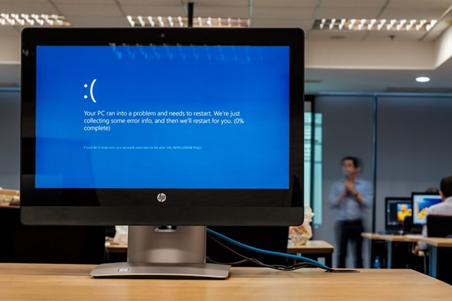 People affected by ClowdStrike's global software outage are reporting seeing blue screens like this when they try to use their Windows 360 computers. - Shutterstock / Thannaree Deepul