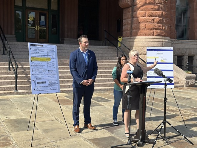 Bexar County Republican Party Chairwoman Kris Coons points to a copy of a document showing that Democrat Kristian Carranza legally changed her last name in 2023. - Michael Karlis