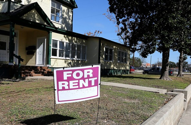 A "For rent" Signs stand in the yard of a home in San Antonio. - Ben Olivo