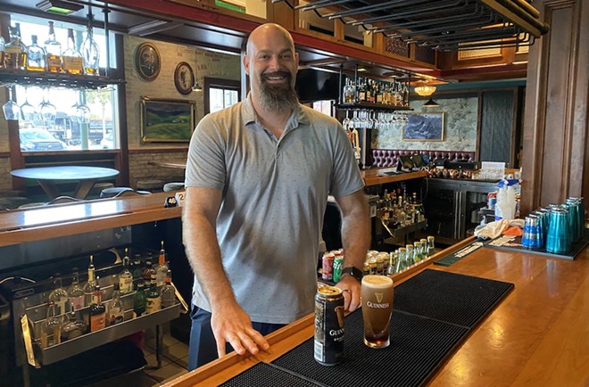 Trey Darilek of the Mahoney Bar Group's new leadership pours a Guiness at St. Paul Square's Francis Bogside. - Sanford Nowlin