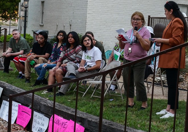 Soap Factory tenant Carmen Cruz tells her story during Monday's rally. - Adam Doe