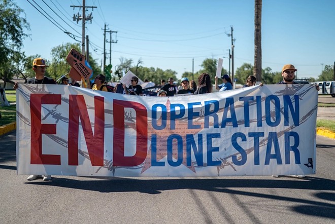 Protesters march toward Shelby Park on Saturday, Sept. 28, 2024, in Eagle Pass, Texas. A rally was held near Shelby Park protesting the current occupation of the park by the Texas Department of Public Safety as part of Operation Lonestar. The park, which became a global focal point for illegal border crossings, was once open to the public but is now closed to the public and heavily fortified. - Texas Tribune / Sergio Flores