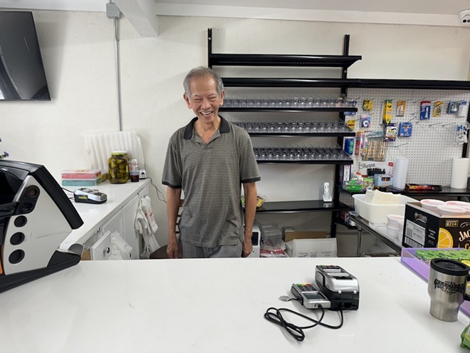 Minh Lam stands ready to serve customers at the grand reopening of Three Amigos Chinese Food. - Stephanie Koithan