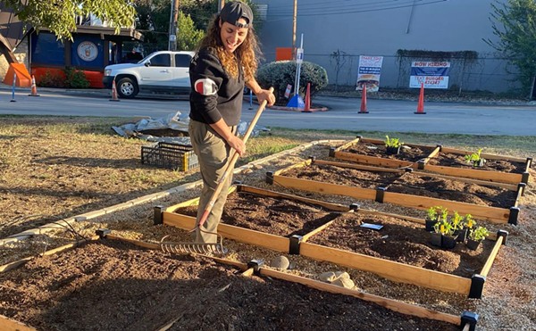 Jess Rivera helps build a garden in front of Little Death Wine Bar.