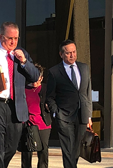 Attorney Michael McCrum and Carlos Uresti exit U.S. federal courthouse.