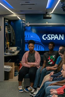 A Harris County precinct commissioner visits with students on the C-Span bus.