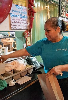 Maria Beza, owner of Maria’s Cafe on Nogalitos Street, completes an order on Thursday.