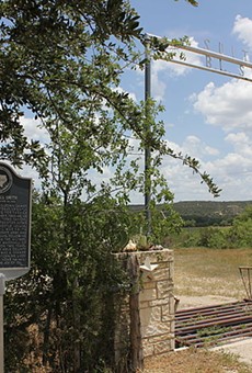 A historical marker stands along the road in Kimble County.