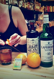 Bartendress Holli Medley crafting a Smooth as a Hot Comb cocktail.