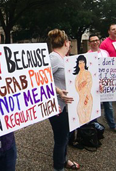 Planned Parenthood supporters hold signs at a San Antonio rally in 2017.
