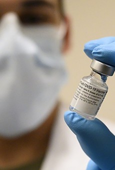 A medical professional holds a vial of the COVID-19 vaccine.