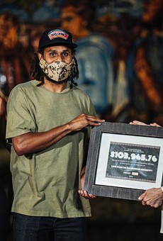 Spurs guard Patty Mills presents a $104,000 donation to Family Violence Prevention Services last year as part of a fundraiser he organized.