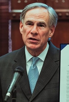 Order Up: Gov. Greg Abbott displays another executive order he signed last year.