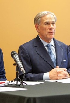 Gov. Greg Abbott (center) appears with State Rep. Briscoe Cain (left) and Sen. Paul Bettencourt, Republican lawmakers who pushed the state's restrictive new voting laws.