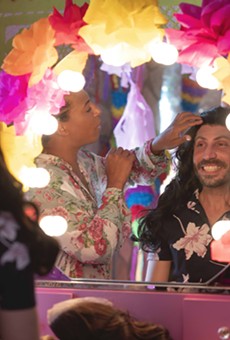 Del Rio Mayor Bruno Lozano (right) tries on a wig in preparation for his drag performance.