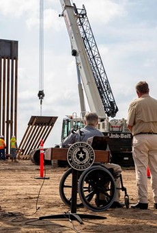 Gov. Greg Abbott watched a crane lifting a section of the border wall in place near the Rio Grande after he unveiled the new wall during a press conference last week.