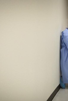 A nurse briefly rests against a wall in the COVID-19 unit at Doctors Hospital at Renaissance Health System in Edinburg.