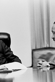 Martin Luther King Jr. makes a point to President Lyndon B. Johnson in the White House Cabinet Room.