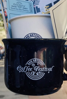A San Antonio Coffee Festival attendee shows off their swag from the 2020 event.