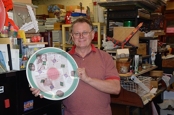 Gene Elder with one of his LGBT history plates. - BRYAN RINDFUSS