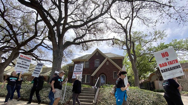 Musicians picket in front of the home of Kathleen Weir Vale, board chair for the Symphony Society.