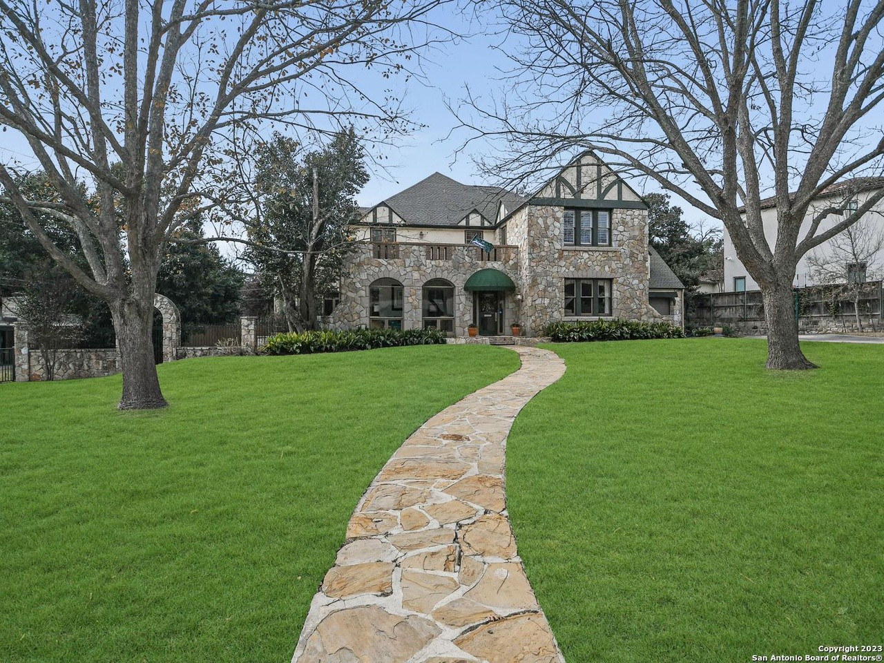 A stone mansion in San Antonio's Olmos Park area with 3 second-floor balconies is now for sale