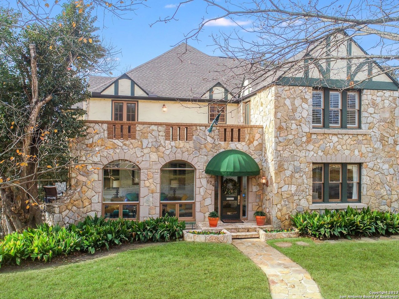 A stone mansion in San Antonio's Olmos Park area with 3 second-floor balconies is now for sale