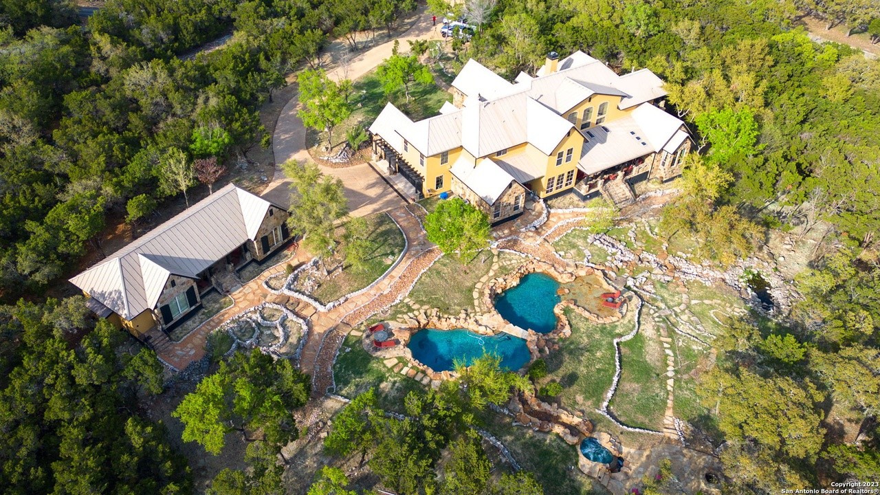 This San Antonio mansion for sale looks like a farmhouse but has multiple swimming pools